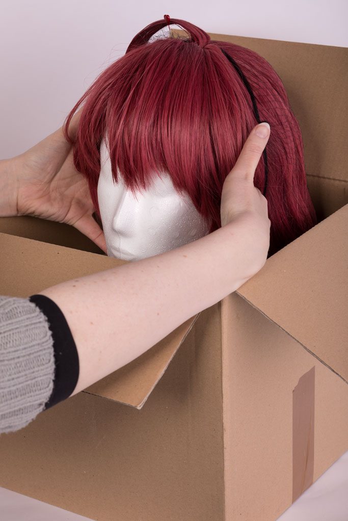 lower the wig head into the box