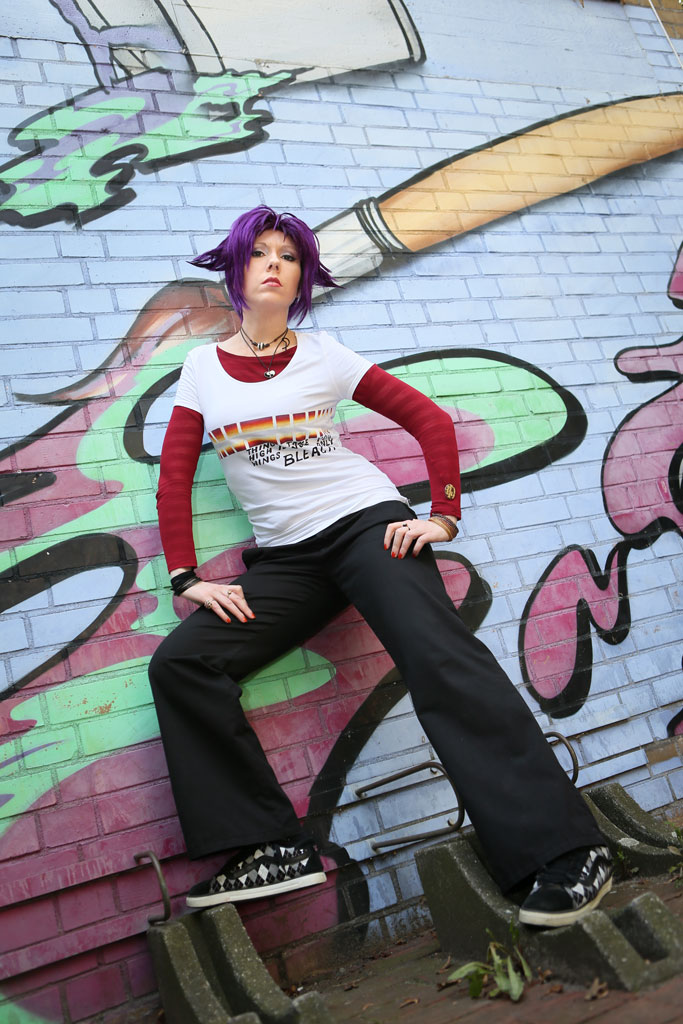casual cosplay in front of graffiti wall