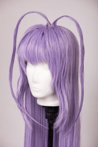 lilac wig with bangs and two long strands of hair sticking out